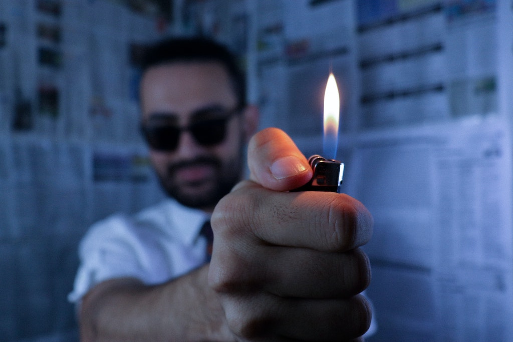 Man with a lighter to light man candle